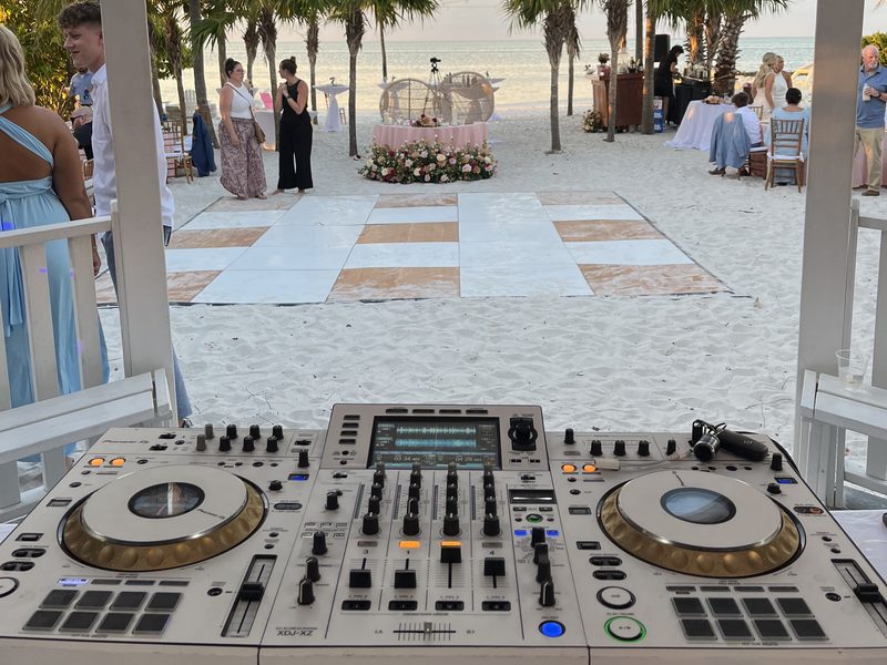 On Deck DJ booth at a beachfront wedding at sunset